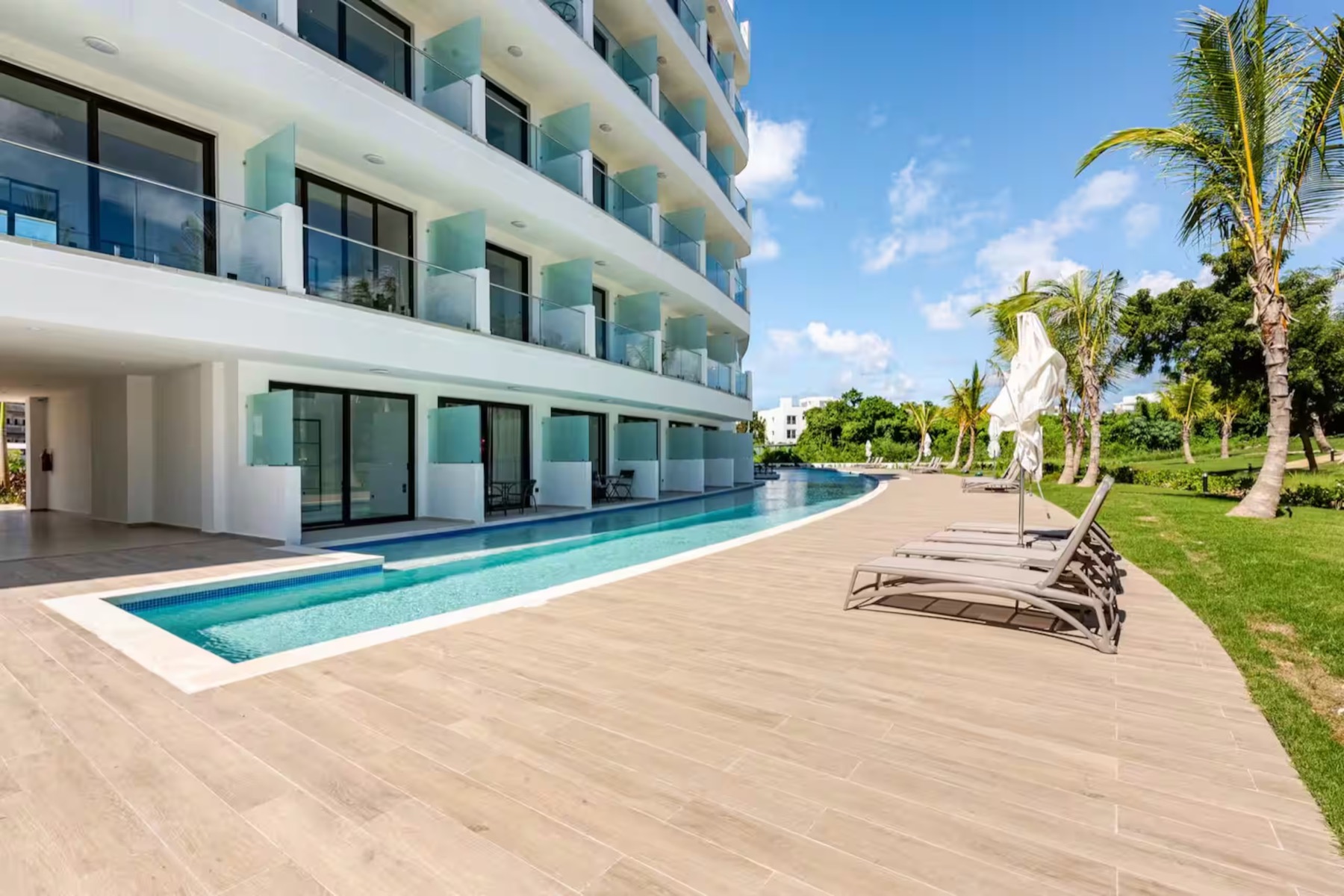 Cana Rock Universe building with swim-up terraces along a curving pool