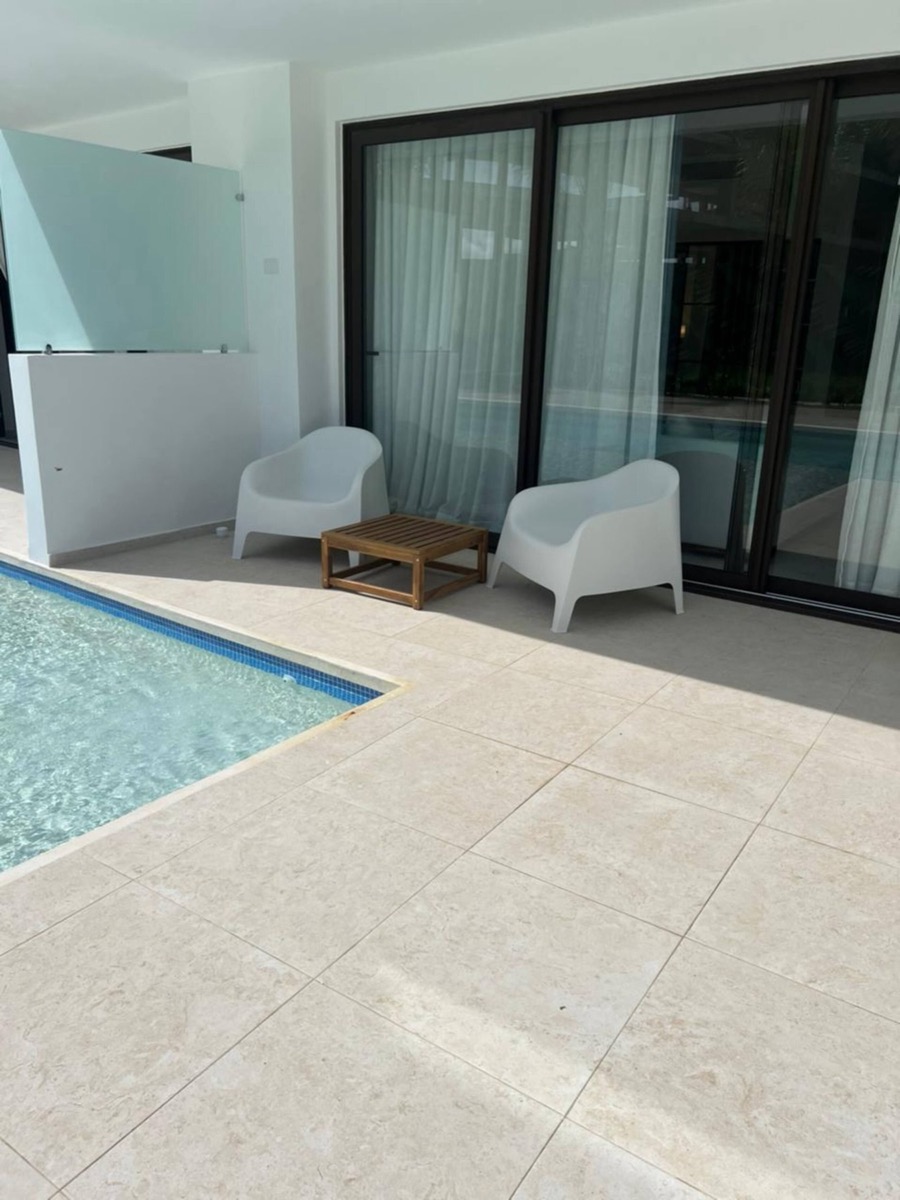Private terrace with two lounge chairs next to the pool